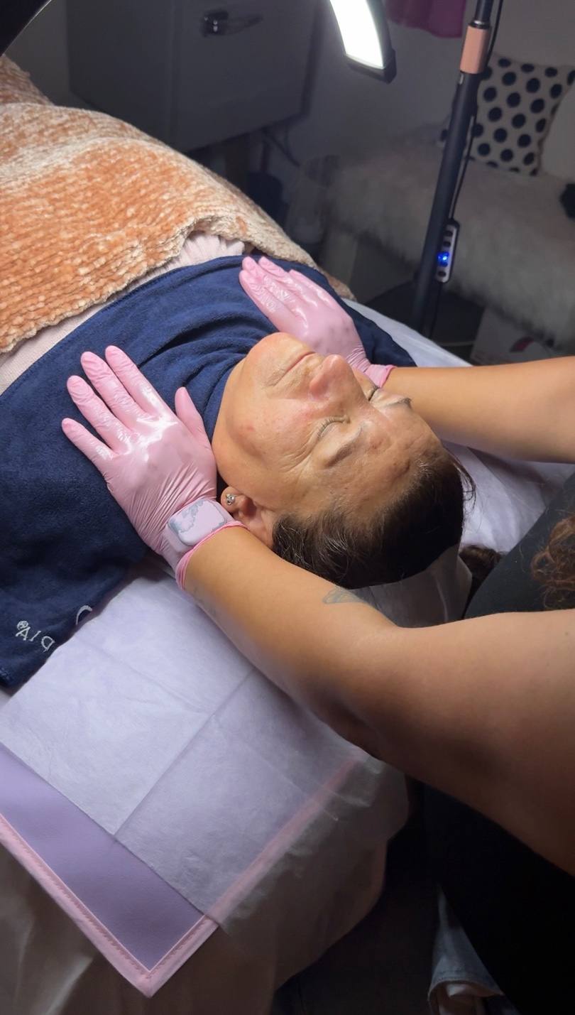 Licensed esthetician performing facial treatment at Full Circle Beauty Point Loma